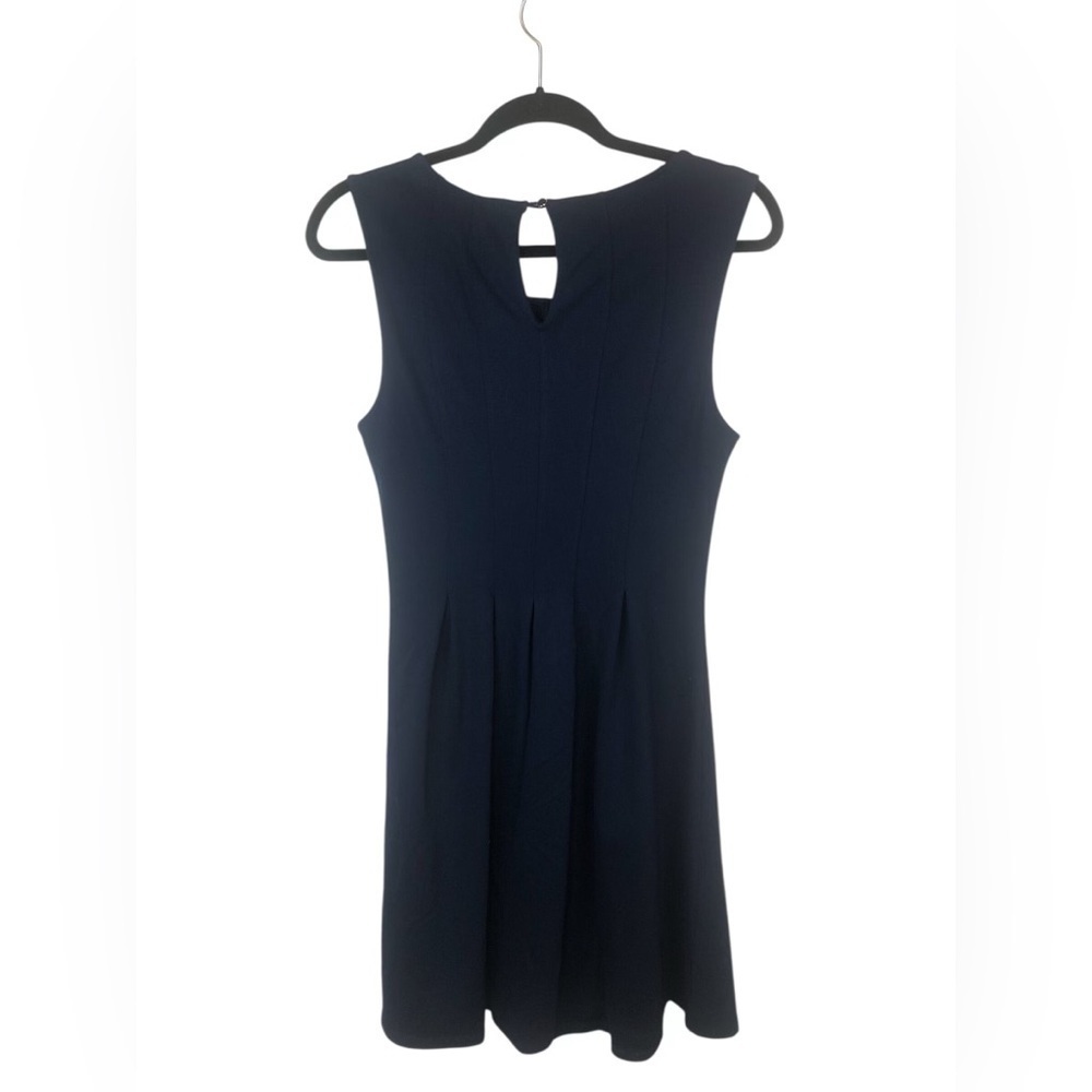Monteau navy dress with an A line skirt and pleats. High necked w/ key hole.